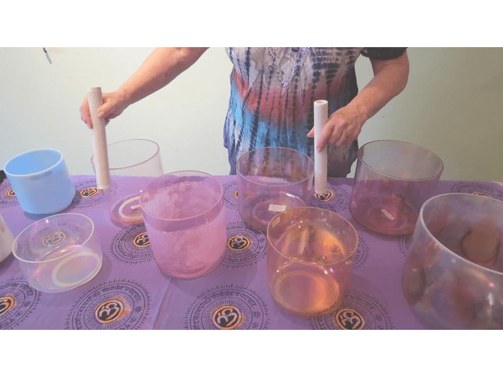 A person standing over some cups on a table