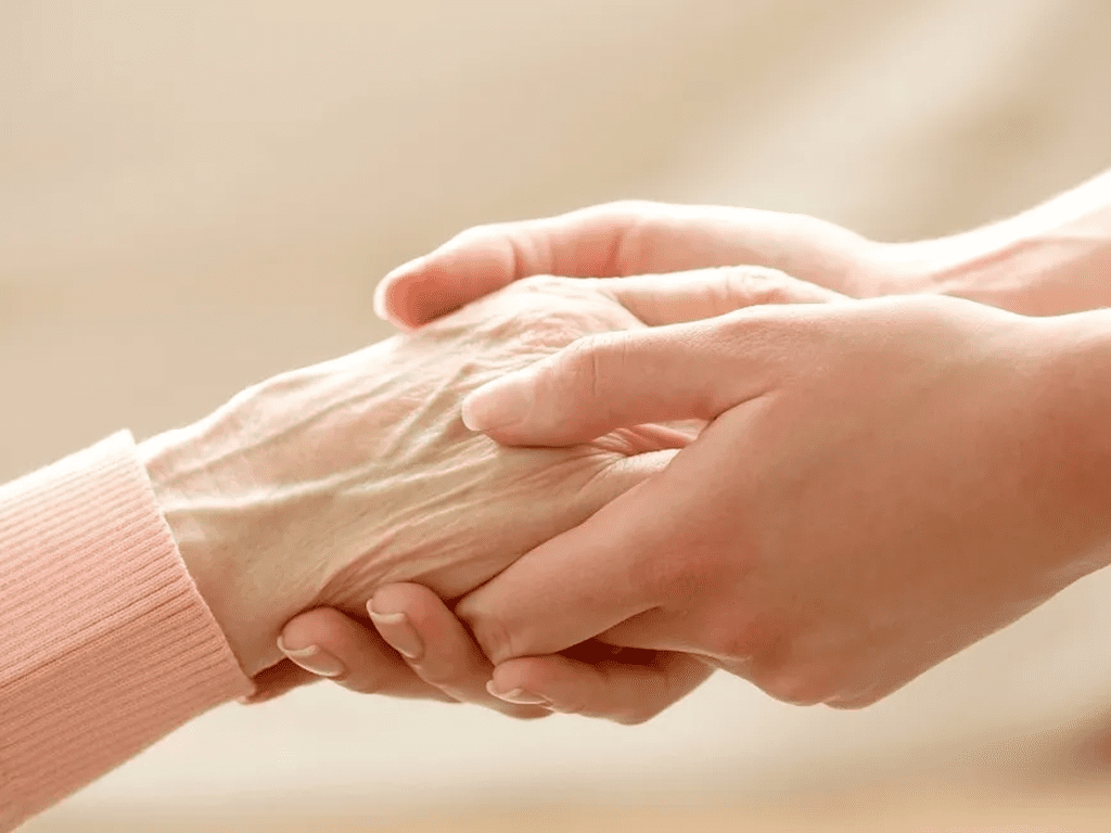 A person holding someone 's hand in front of them.