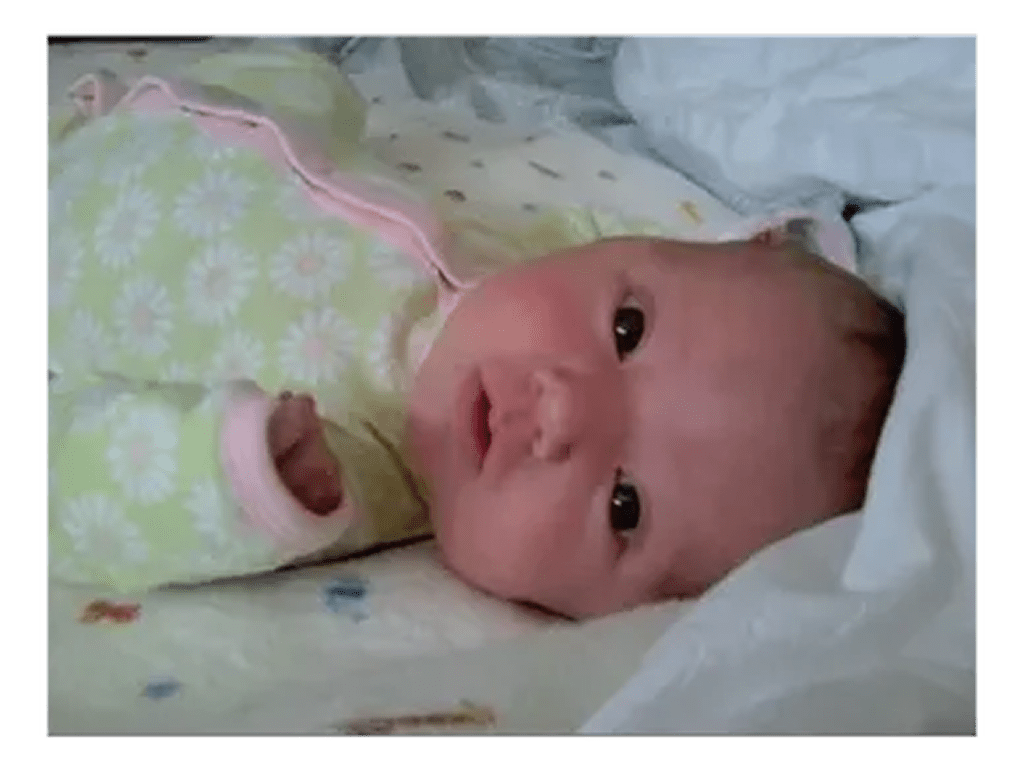 rs=w_1280 (3)-2 A baby laying in bed with its head on the pillow.