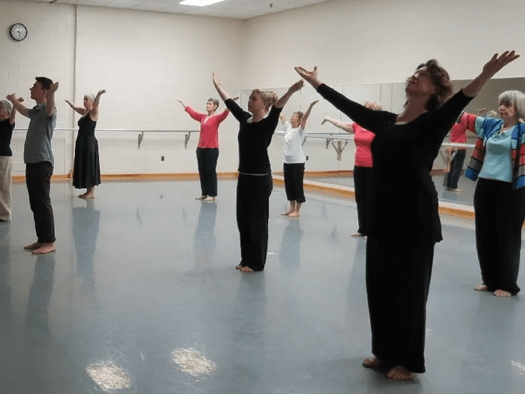 A group of people in black clothes doing different exercises.