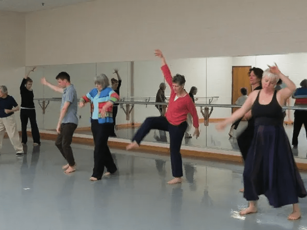A group of people in a room doing different things.