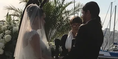 A bride and groom are standing together at their wedding.