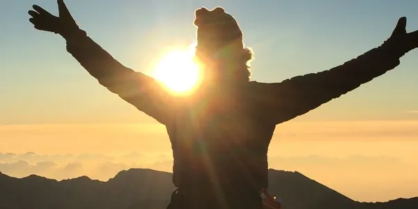 rs=w_600,h_300,cg_true (3) A person standing in the sun with their arms outstretched.