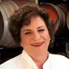 A woman in white shirt smiling for the camera.